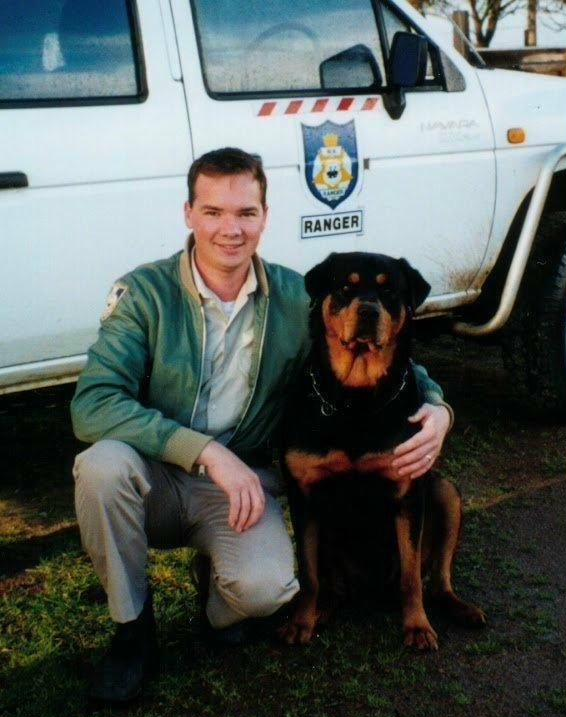 Darren as a younger man working as a Shire Ranger for Denmark WA. Picture shown here with his well trained secuirty dog 'Bear'